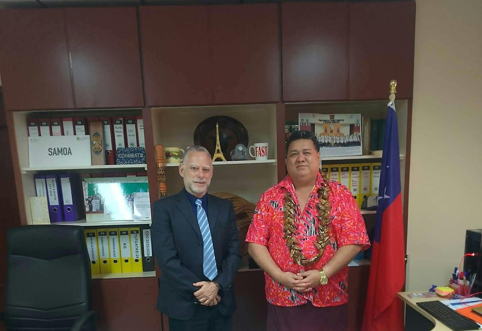 Ambassador of Israel Alon Roth and Minister Fata Ryan Schuster standing beside the Samoa flag